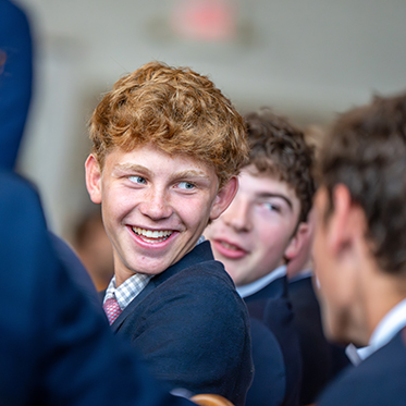 A student smiling. Links to What to Give