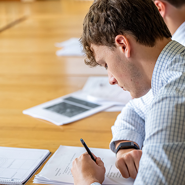 A student working on an essay. Links to Donor-Advised Funds
