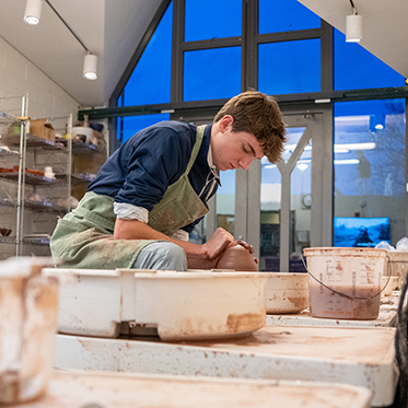 A student in pottery class. Links to Gifts of Life Insurance