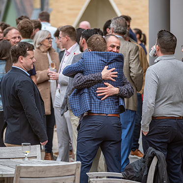 People greeting and hugging each other. People greeting and hugging each other.